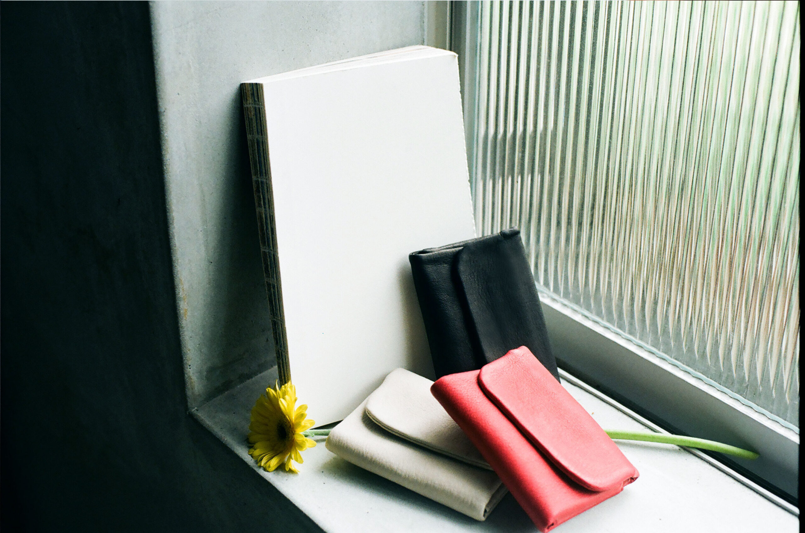 deer leather wallets made from natural materials in soft window light