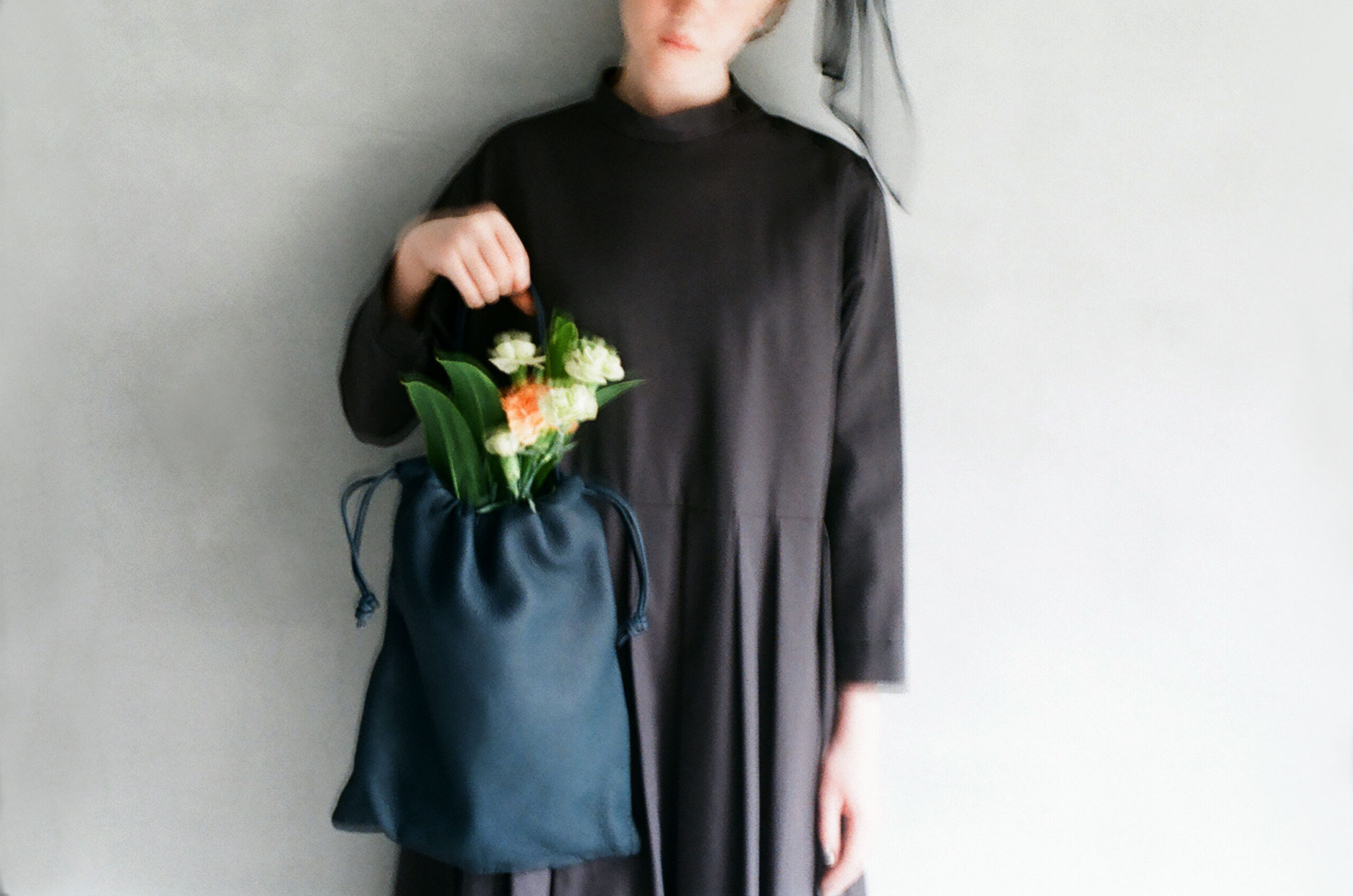 hands holding a soft deer leather bag with natural texture