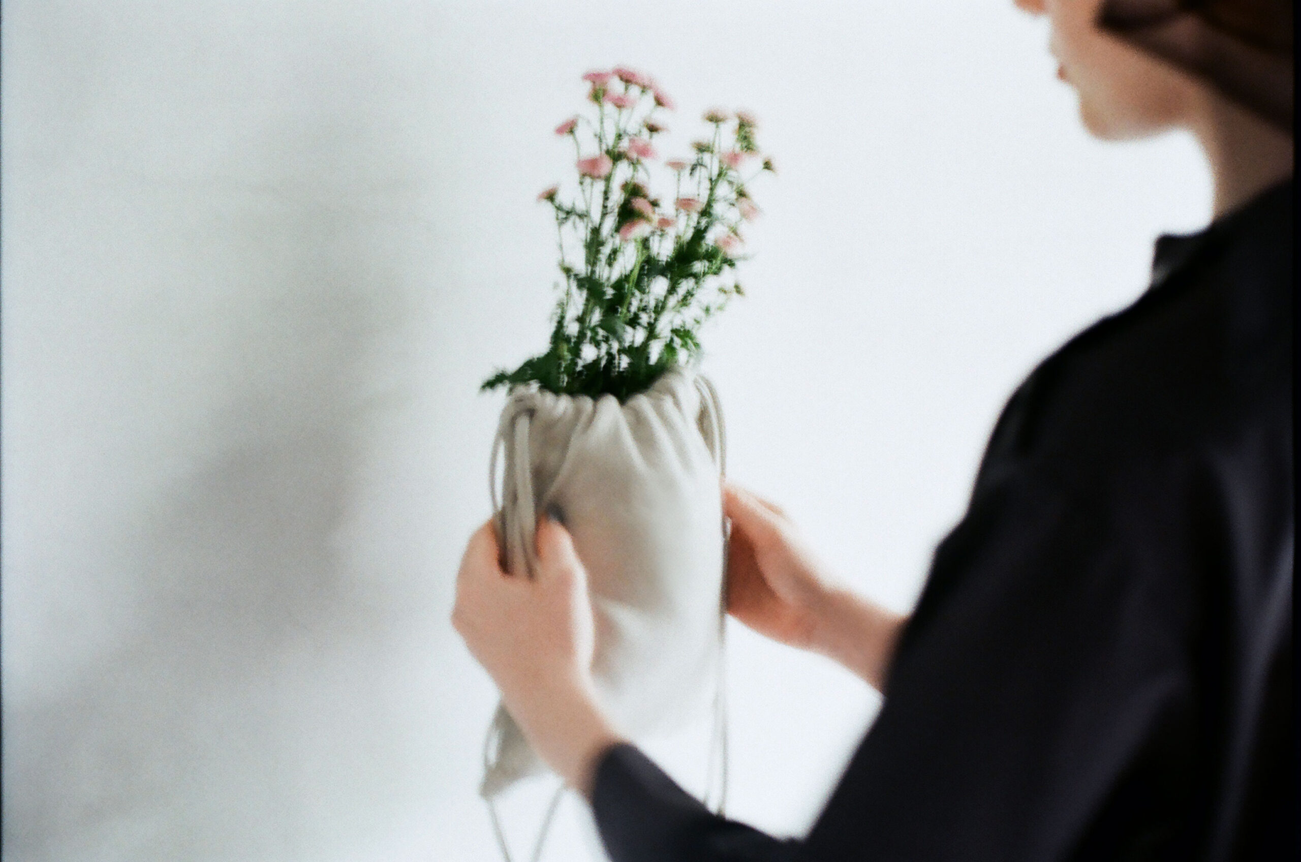 hands holding a soft deer leather bag with natural texture