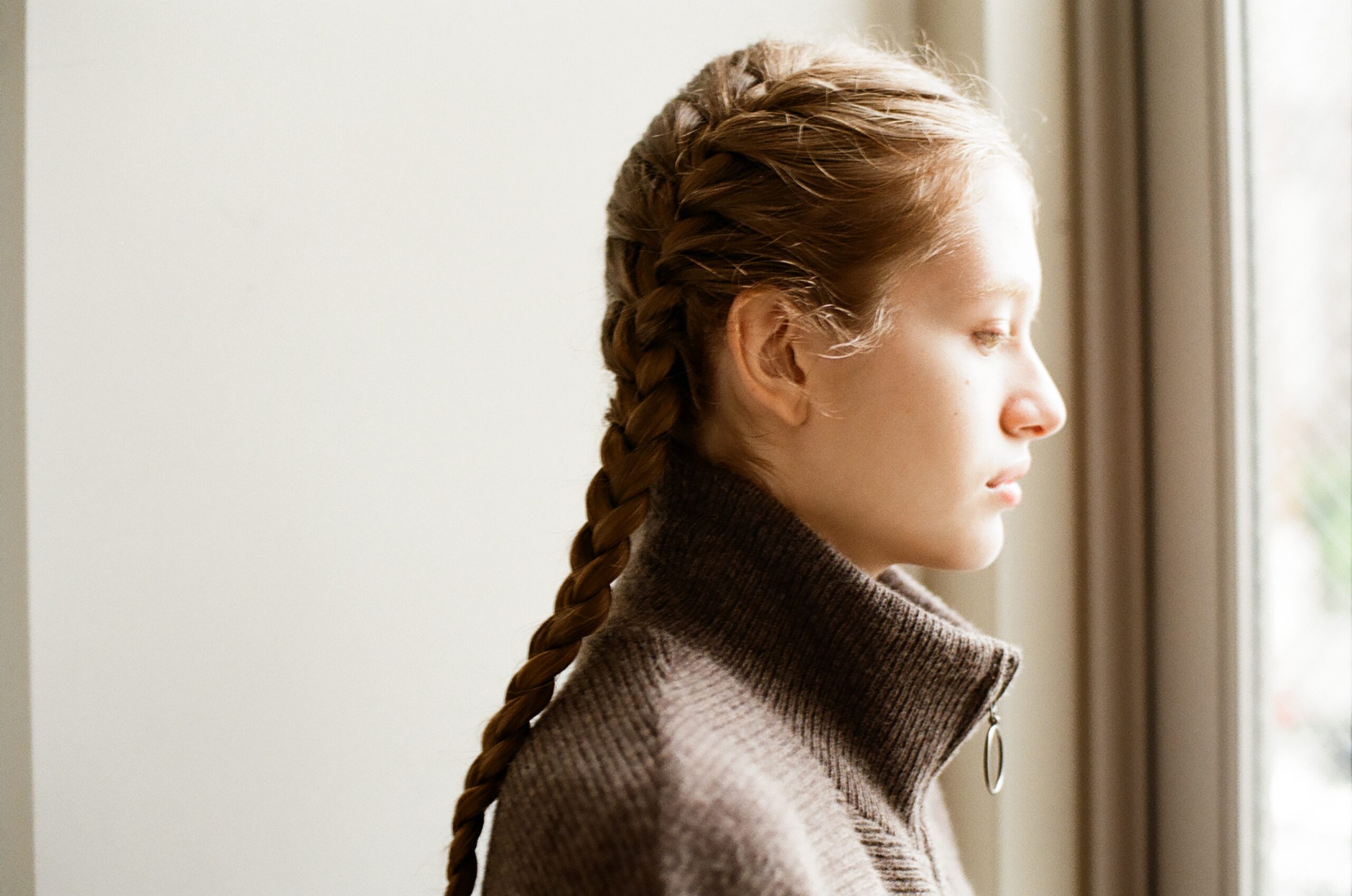 Side profile of a model wearing a high neck knit in the Mochi 2026 Autumn Winter image look.